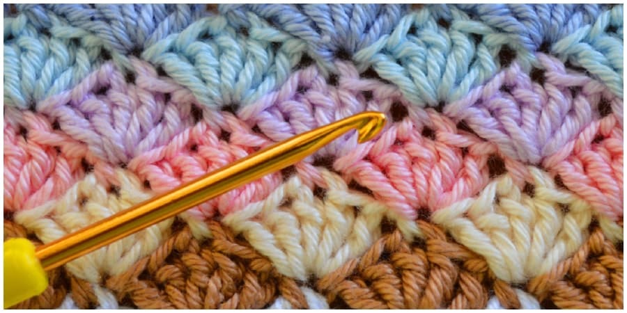 The shell stitch is a fairly simple stitch that creates an intricate shell pattern. You can work it in rows, in the round, or as a blanket edging.